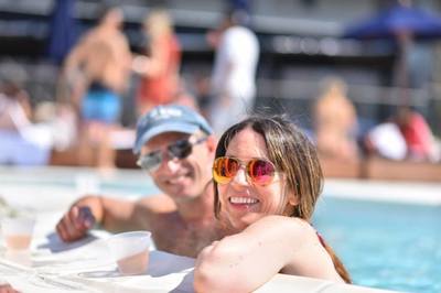 Two friend enjoy the pool at our oceanfront hotel during their Hamptons vacation. 