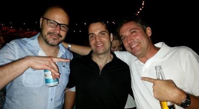 Three guys with beers out in the Hamptons.