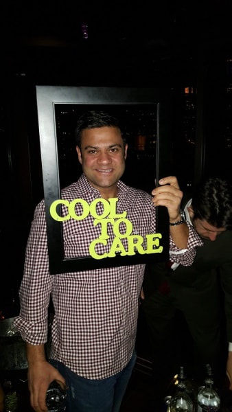 Man posing with a prop at a party for NYC singles. 
