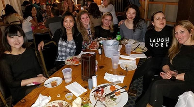 Group of friends eating dinner on their ski resort vacation to escape NYC. 