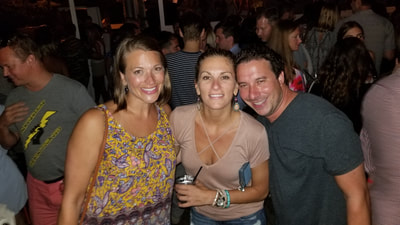 Friends enjoying the nightlife of the Hamptons during their weekend vacation. 
