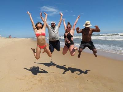 Four friends jumping on the beach during their Hamptons weekend get away. 