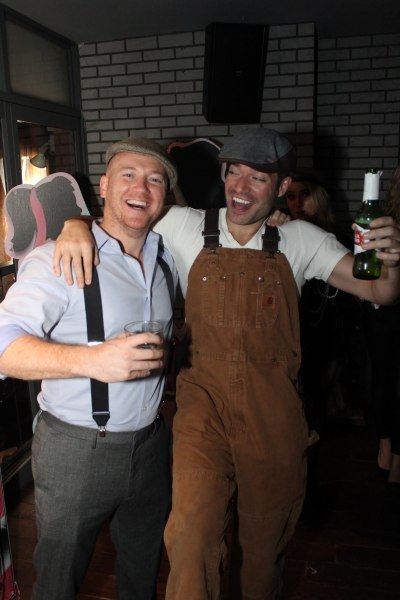 Two guys with beers at a halloween party in NYC.