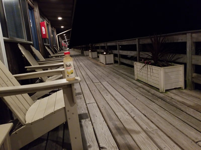 The deck of our oceanfront hotel in Montauk at night with a bai. 